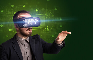 Businessman looking through Virtual Reality glasses, social media concept