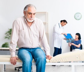 Old couple visiting young male doctor