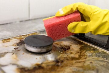 dirty kitchen stove, empty and full bottles of detergents around.