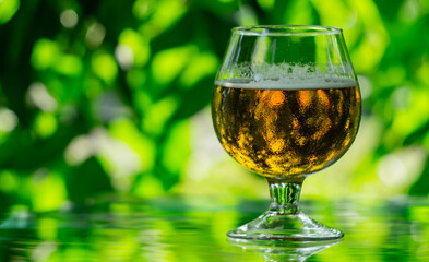 glass with drink on green blurred background