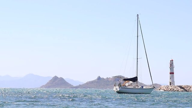 Slow motion Sailing Boat, Lighthouse and the Island (50 fps to 25 fps)