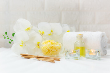 Obraz na płótnie Canvas Thai Spa Treatments aroma therapy salt and nature green sugar scrub massage with orchid flower on wooden white with candle. Thailand. Healthy Concept
