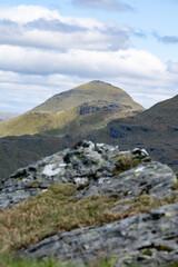 Fototapeta na wymiar View of a steep hill peak called Ben More from An Caisteal. Beautiful Scottish mountain scenery in summer 