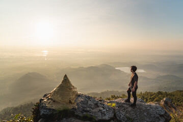 Fototapeta premium A man hike to top of mountain to see sunset and good view
