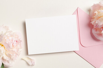 Wedding invitation card mockup with envelope and pink peony flowers