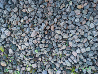 Top view gravel texture. Small road stone background. Dark gravel pebbles stone texture seamless texture.