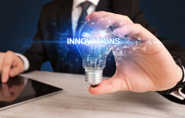 Businessman holding a light bulb