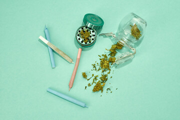Jars with dry marijuana buds and rolled joint