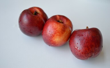 Fresh organic nectarines on a white background