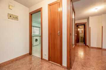 Hall of a house with wooden doors, fitted wardrobes, fuse box and access to other rooms