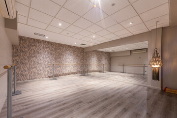 dance workout room with a mirror covered wall and wooden walkways with hardwood floors