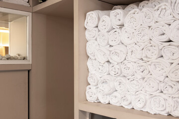 Lots of rolled up white towels in a beauty salon
