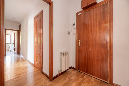 Entrance hall of a house with parquet floors, mahogany carpentry and aluminum radiators