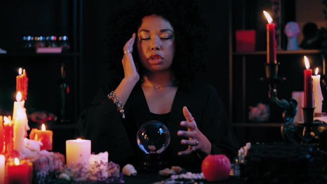 Medium gazing into crystal ball, contacting ghosts in a state of trance, magic