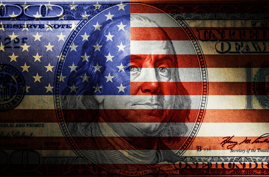 Economics and finance. A dollar bill in close-up and an American flag, double exposure. Picture of Benjamin Franklin. Concept of crisis of the banking system