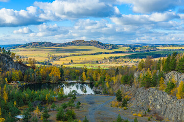 flooded quarry with trees around in autumn
