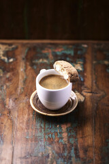 Cantuccini (Italian cookie) and a Cup of coffee on rustic wooden background. Copy space.