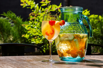 Juice with peaches and cherries in a glass