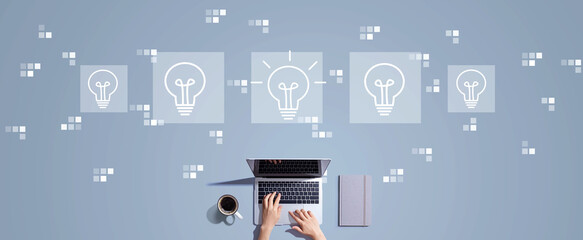 Idea light bulb theme with person working with laptop