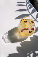 Cocktail with ice, pear and buds of small roses
