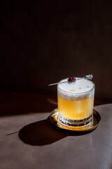 Cocktail with froth, ice and cherries