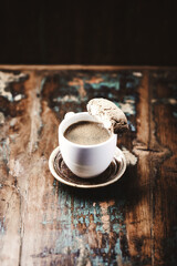 Cantuccini (Italian cookie) and a Cup of coffee on dark wooden background. Copy space	