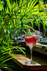 A cocktail with ice and a flower