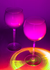 Two Glasses of an light purple Alcoholic Cocktails on a Dark Background with smoke and backlight. Very dangerous fire cocktail - close up photo. Background picture. Selective focus.