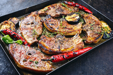 Barbecued lamb saddle back chop steaks with chili and eggplants served as close-up on a rustic...