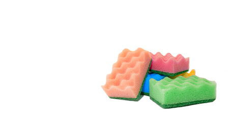 Stack of colorful kitchen cleaning sponges with soap bubbles on white background.