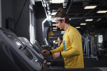 Young sportsman walking on a treadmill