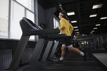 Full length shot of an athletic man cardio training, running on treadmill