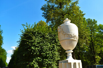 stone statue against the background of green trees