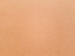 Orange color paper texture and grain for aesthetic of autumn and fall design. Color and light on warm earth tone paper background.
