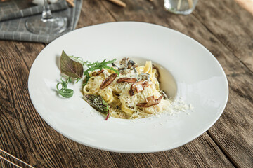 Portion of italian tagliatelle pasta with mushrooms