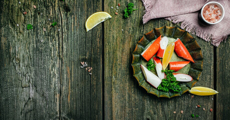 Fresh Sliced Crab Stick Slices Surimi on Wooden Board. Ready to Eat. Long banner format. top view
