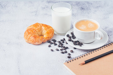 fresh coffee with croissant and milk for breakfast in the morning, fresh coffee and coffee beans