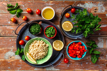 Tabbouleh salad. Middle eastern or arab dish. Levantine vegetarian salad with parsley, mint, bulgur, tomato. Vegan food. Top view