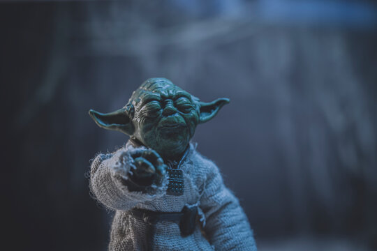 NEW YORK USA, JULY 18 2022: Star Wars scene with Jedi master Yoda meditating with the Force on Dagobah - Hasbro action figure