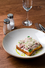 Steak Tartare with bread toasts served on plate. Food a restaurant.