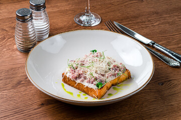 Steak Tartare with bread toasts served on plate. Food a restaurant.