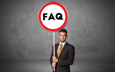 Young business person holdig traffic sign