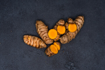 Fresh turmeric on the black background