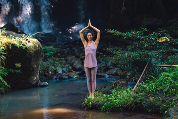 European girl doing yoga and walking in nature.
