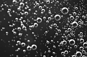 Dark oil with bubbles. Bubbles in liquid. Black and white. Oil concept. Oil business concept and petrol production