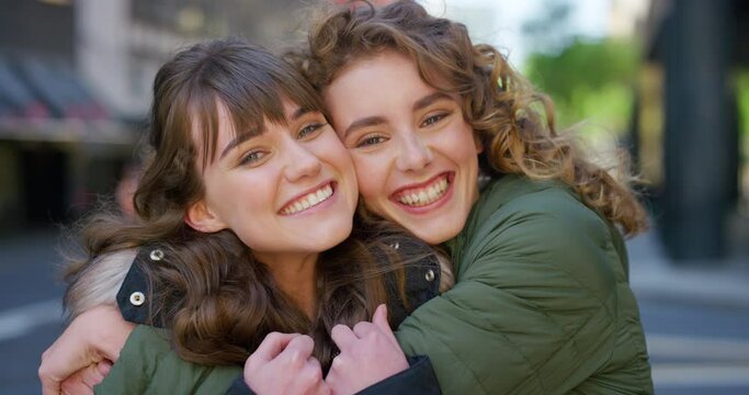 Portrait of two fun women hugging and making happy memories downtown together. Smiling, playful friends embracing, bonding, enjoying a day in a city and showing affection and appreciation in town