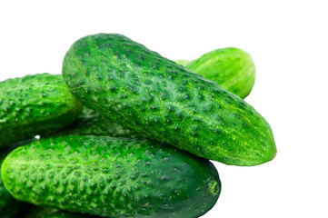green cucumbers on a white background. ripe gherkins on a table. fresh vegetables on a light texture. the concept of growing cucumbers