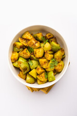 Indian style Tinda or Tinde ki Sabzi also called Indian squash, round melon, Indian round gourd or Indian baby pumpkin, stuffed, stir fried dry or curry recipe