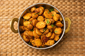 Stir fried taro roots. Arbi ki sabji, ghuiya masala curry Sabzi or arvi dum Masala. Garnished with coriander