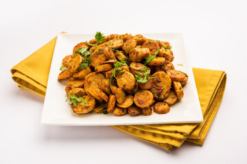 Stir fried taro roots. Arbi ki sabji, ghuiya masala curry Sabzi or arvi dum Masala. Garnished with...